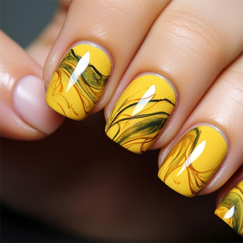 Yellow nails with flowing dark marbled lines.