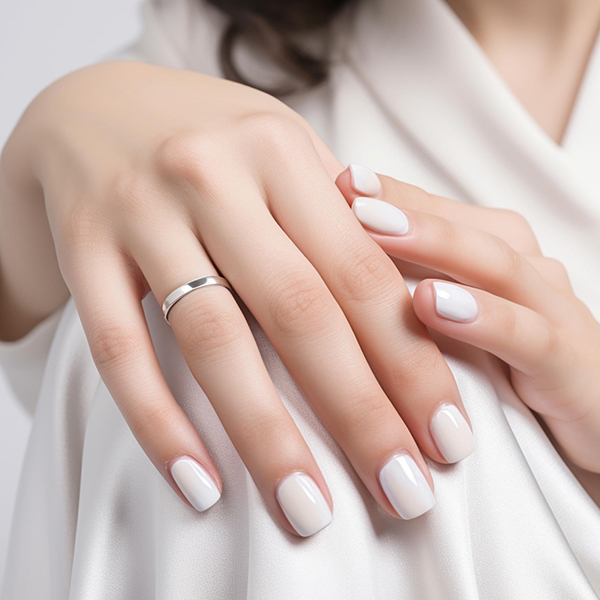 Short square nails with glossy white polish.